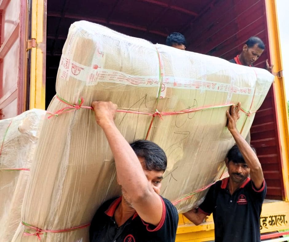 unloading packed bed from truck by om sai packers and movers team's