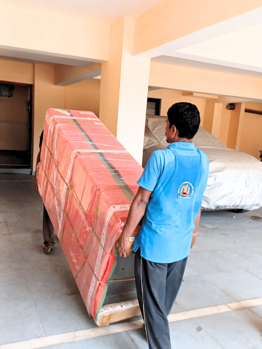 Professional packers movers in Patna carefully lifting and transporting a well-packed household item for safe relocation.