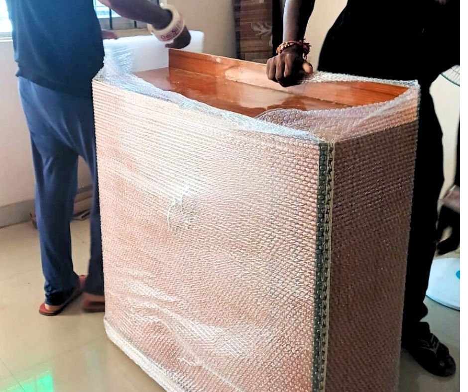 Staff of professional packers and movers in Rajendra Nagar carefully packing household goods for safe relocation.