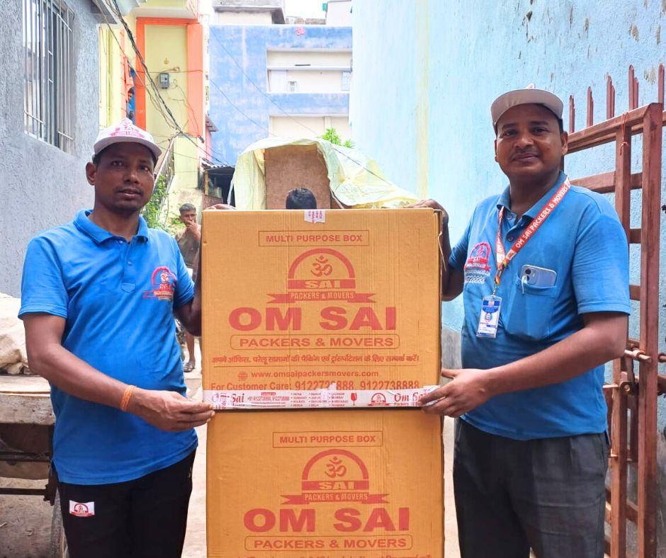 Professional team from Om Sai Packers and Movers in Mithapur handling securely packed boxes during a household shifting process.
